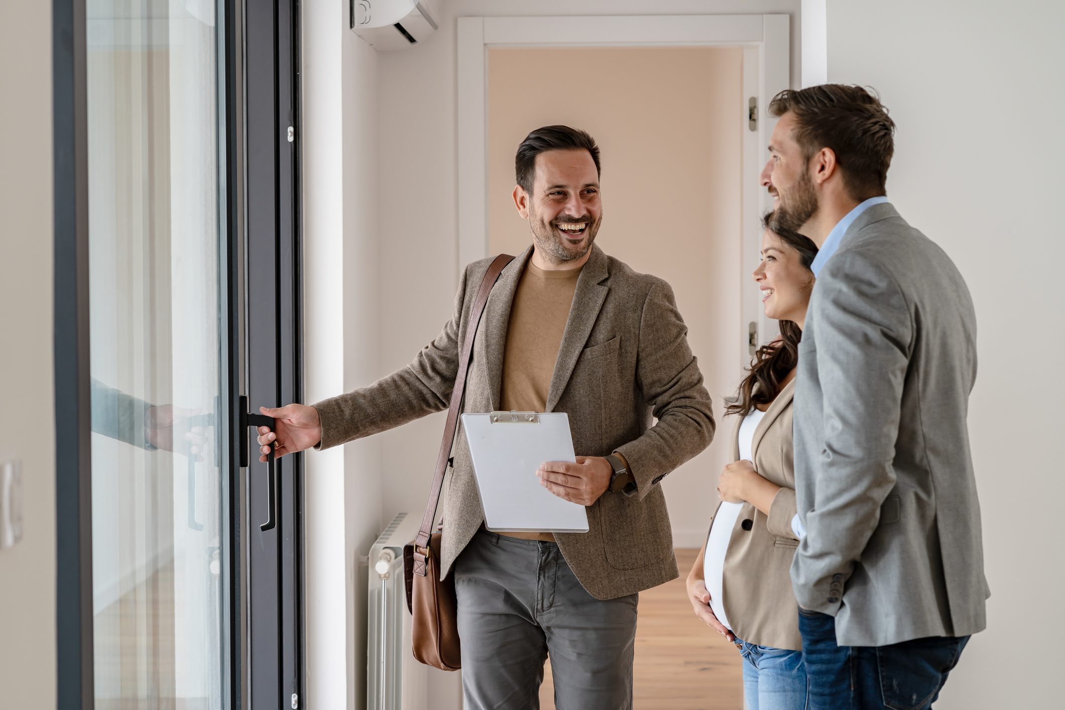 Realtor showing couple a new apartment.